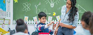 Teacher with student in class