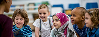 Child being helped at school by teacher 