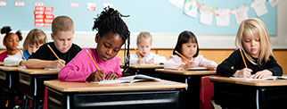 School children working at desks in a classroom 